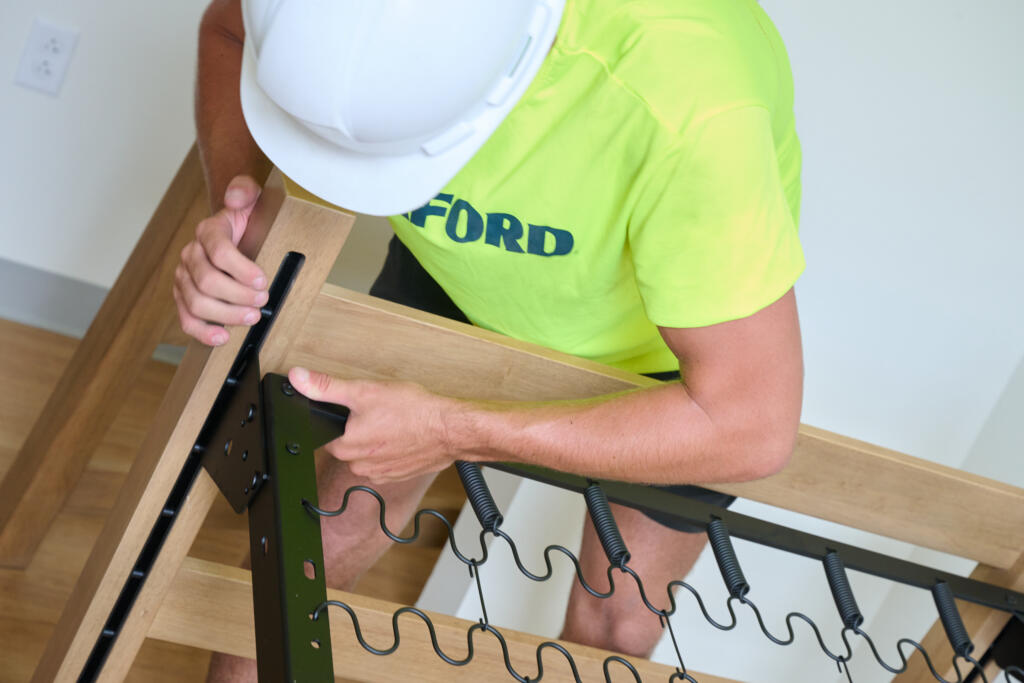 Smarter Furnishings install team assembling a student dorm room bed